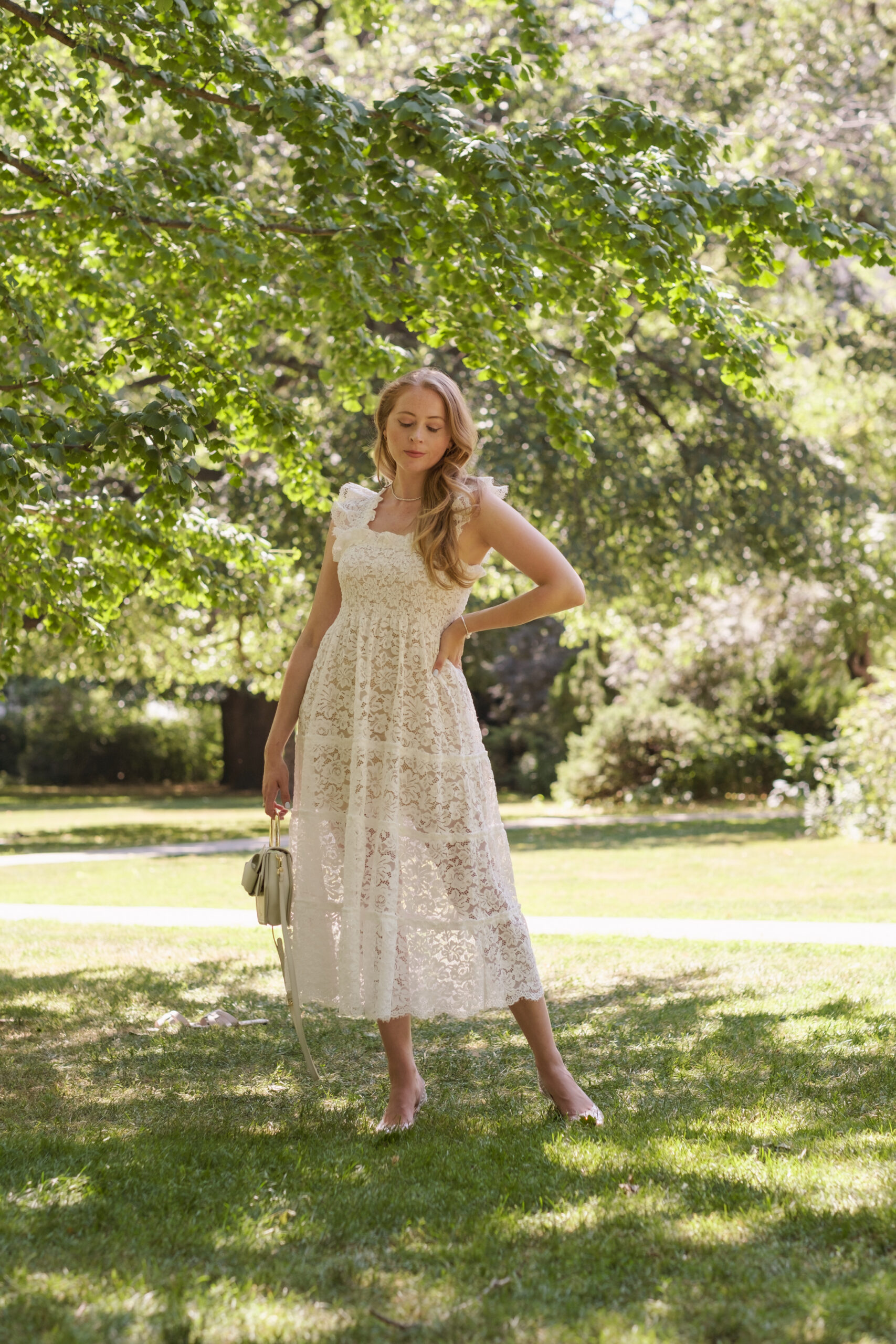 White Lace Nap Dress featuring a see through lace fabric, smocking, stretchy smocked shoulders and a perfect tea length